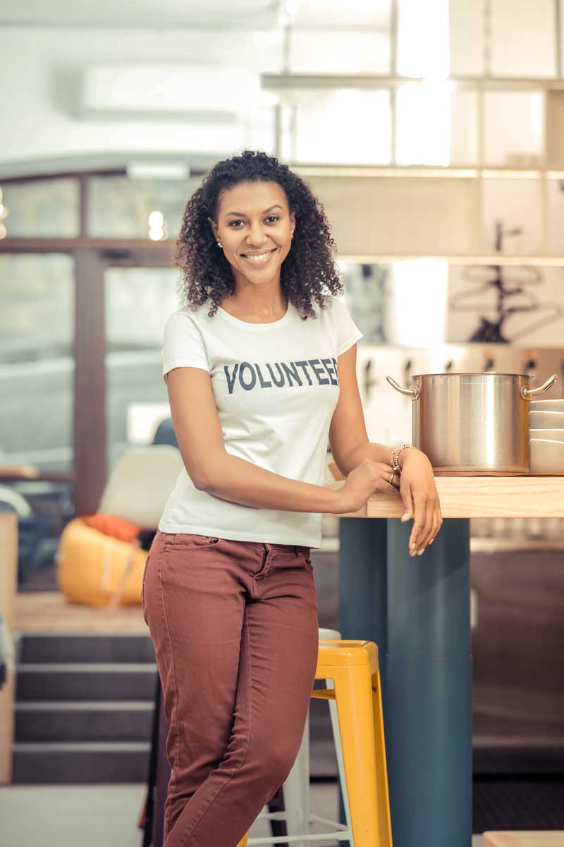 Positive afro American woman working in the kitchen