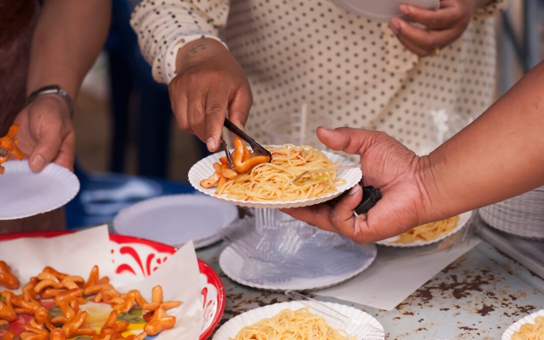 people gathering food from plates